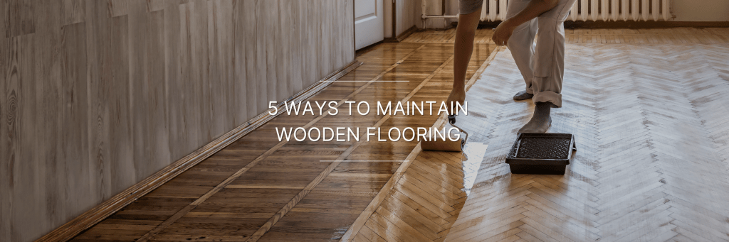 person cleaning and maintaining wooden flooring