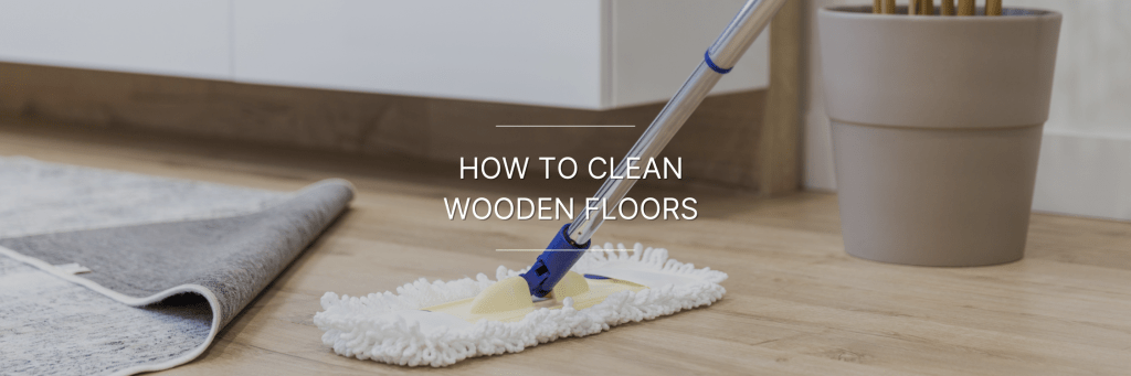 person cleaning wooden flooring