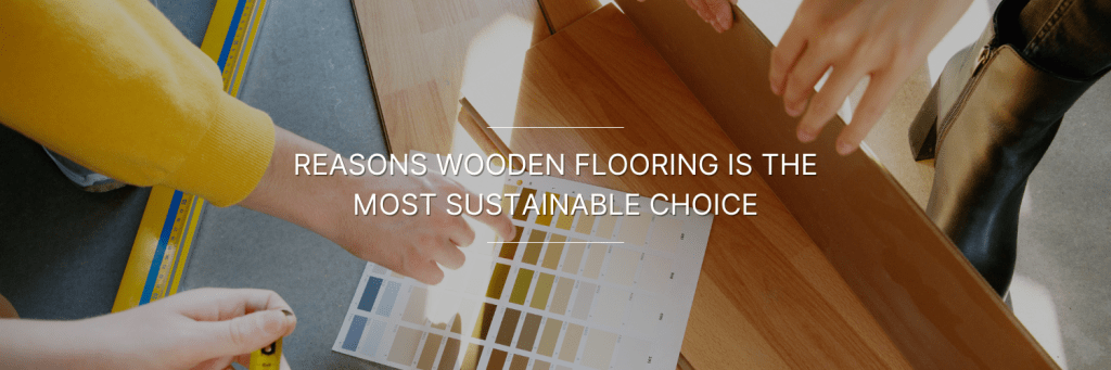 Hands examining wooden flooring samples with a color swatch book