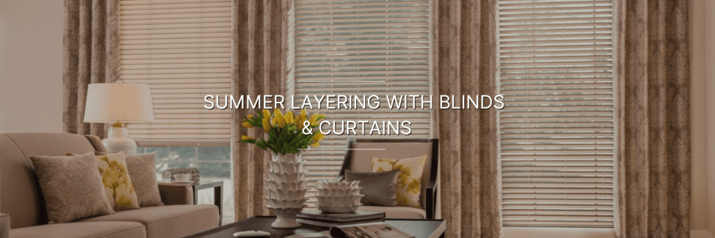Cozy living room featuring elegant blinds and layered curtains, with floral decor and soft furnishings for a summer ambiance.