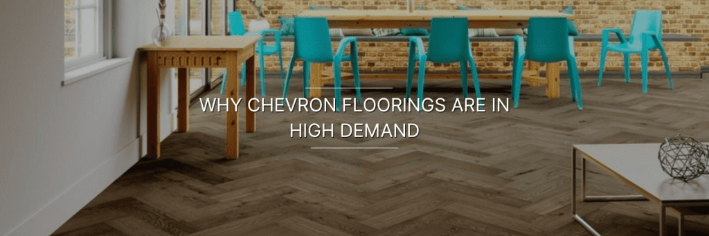 Modern dining space featuring chevron-patterned flooring, a wooden table, colorful chairs, and exposed brick walls.