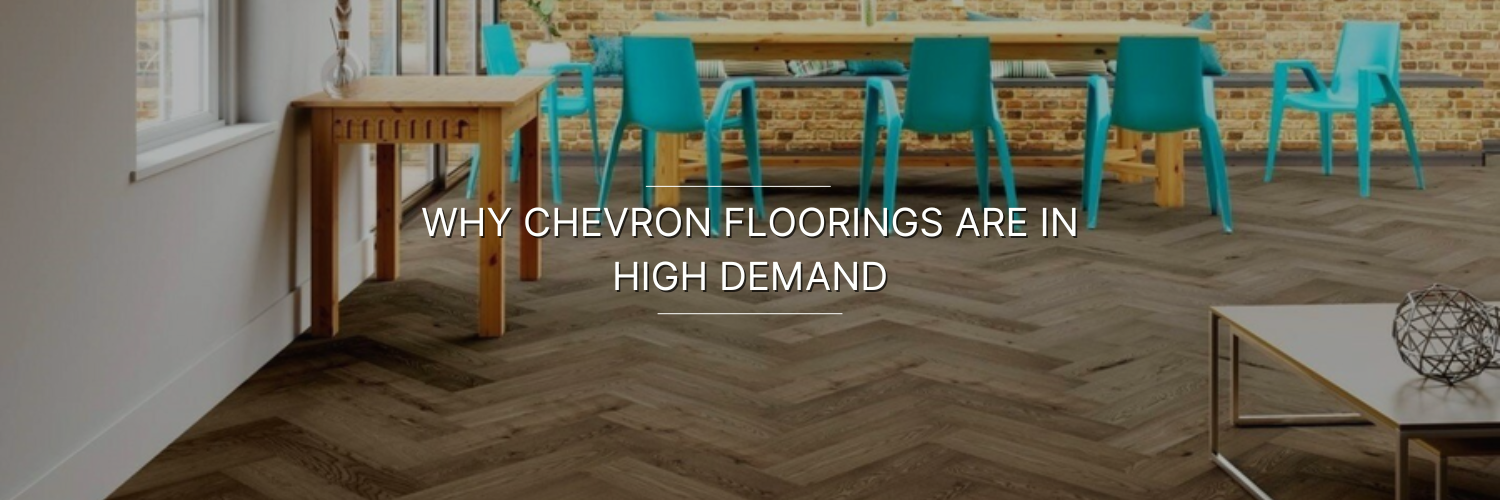 Modern dining space featuring chevron-patterned flooring, a wooden table, colorful chairs, and exposed brick walls.