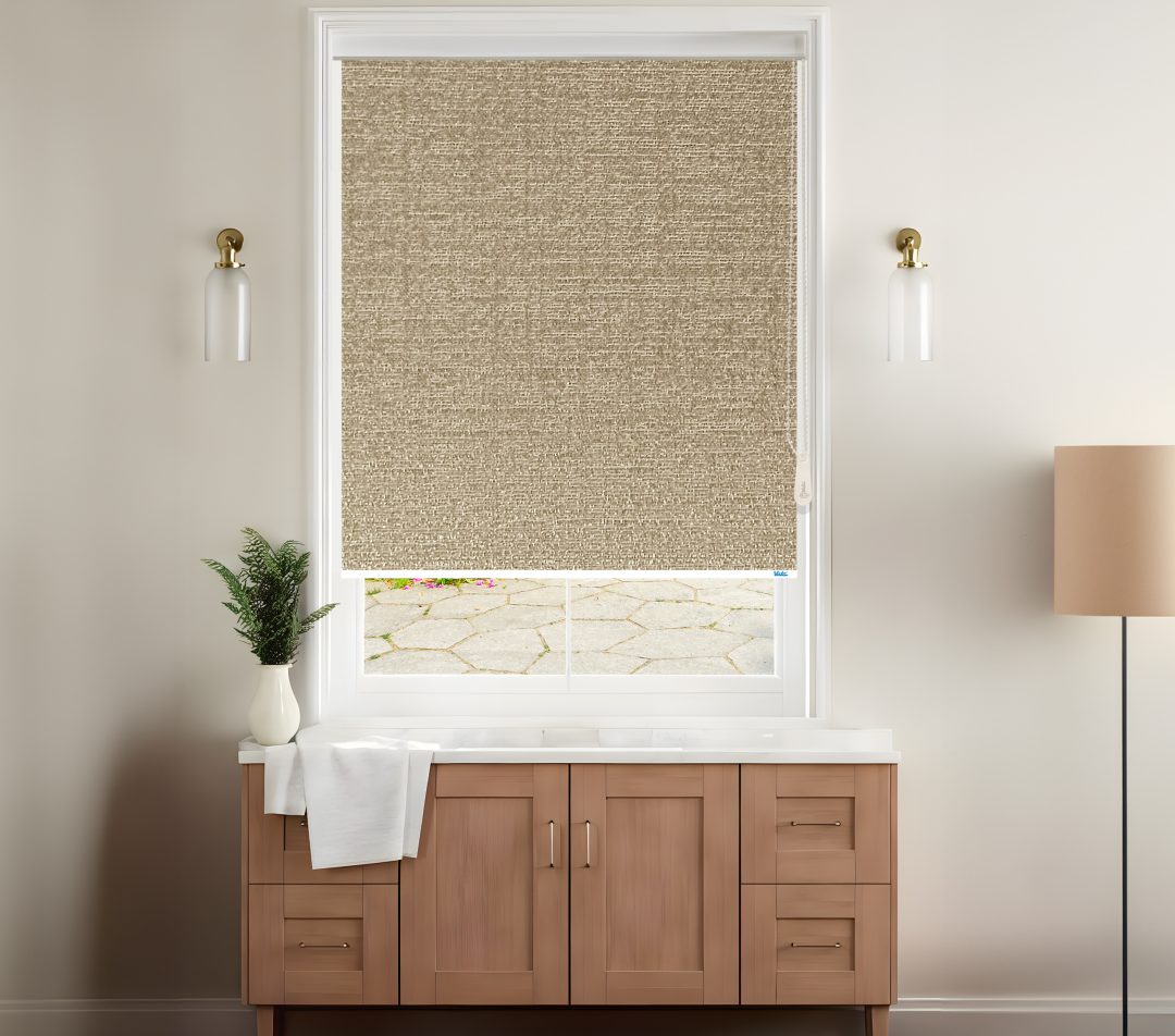 A stylish room features a beige textured roller blinds covering a window with a view of a stone patio, complemented by modern decor.