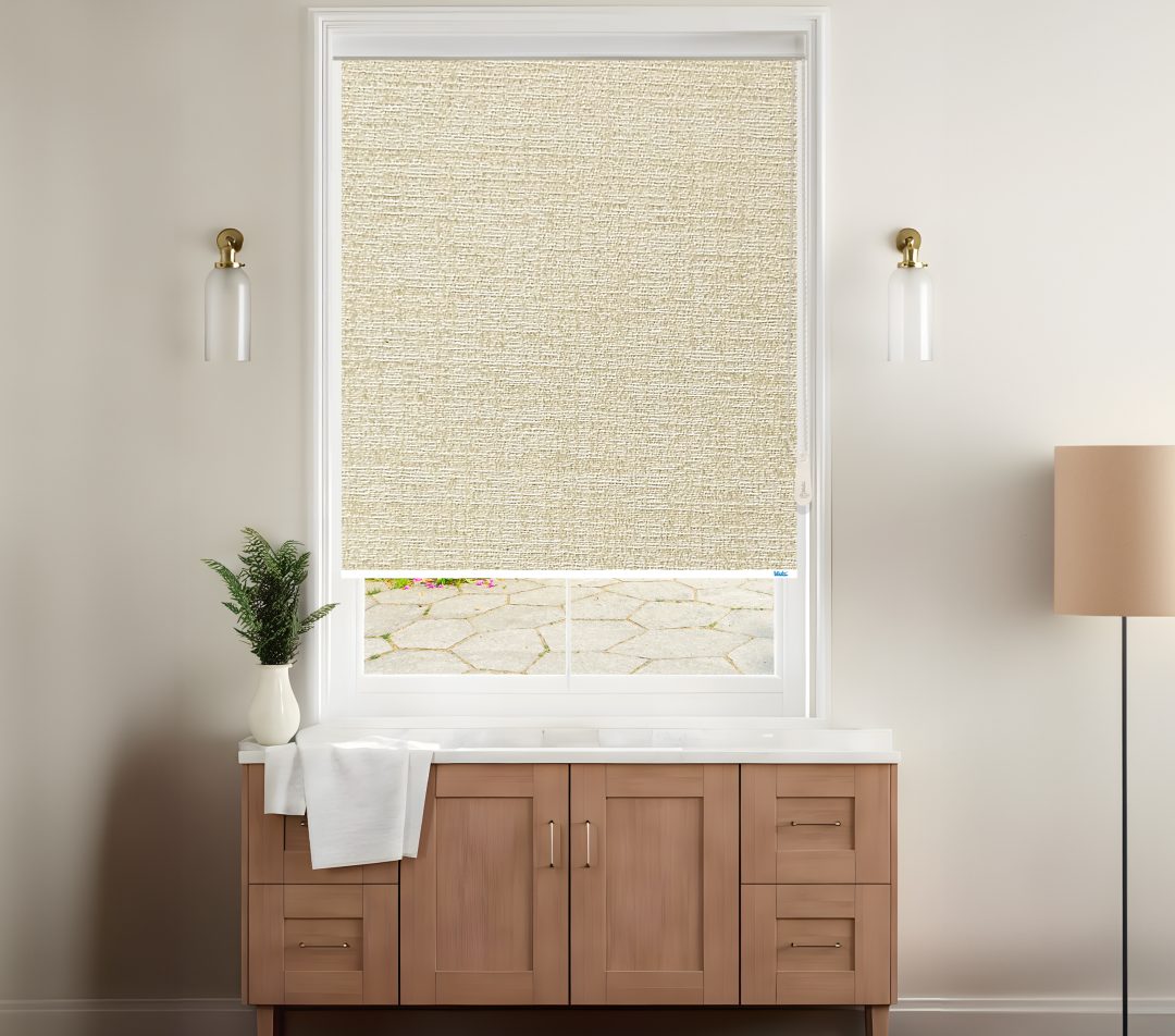 A stylish room features a light beige roller blinds covering a window with a view of a stone patio, complemented by modern decor.