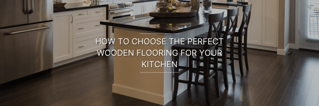 Modern kitchen with dark wooden flooring, white cabinetry, stainless steel appliances, and a dining area with wooden stools.