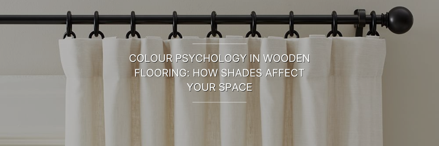 A close-up of light fabric curtains hanging on a black curtain rod, with text about color psychology in wooden flooring.