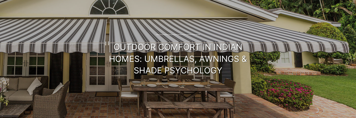 A stylish outdoor patio with a striped awning, showcasing a dining table and comfortable seating, set in a lush garden.