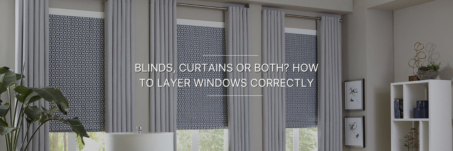 Stylish layered window treatment featuring patterned blinds and gray curtains, complemented by indoor plants and modern decor.
