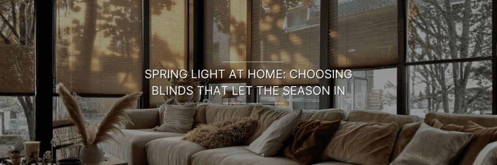 Cozy living room with a beige sectional sofa adorned with pillows. Sunlight filters through window blinds, casting patterns.