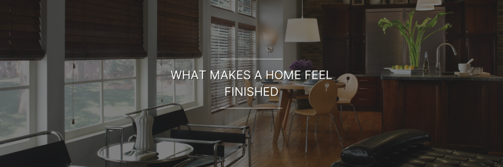 Modern, stylish living space featuring large windows, wooden blinds, and sleek furniture, with a warm, inviting atmosphere.