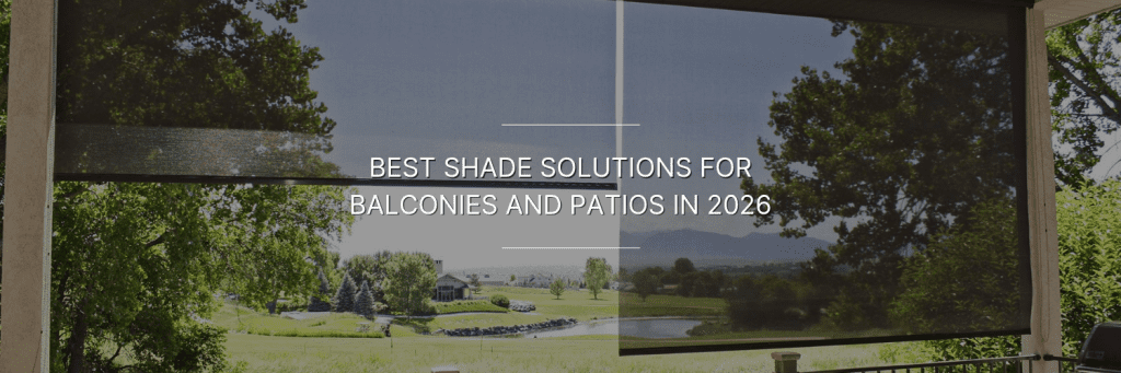 Outdoor balcony with black mesh roller shades partially lowering the sunny view of a lawn, trees, and distant hills.