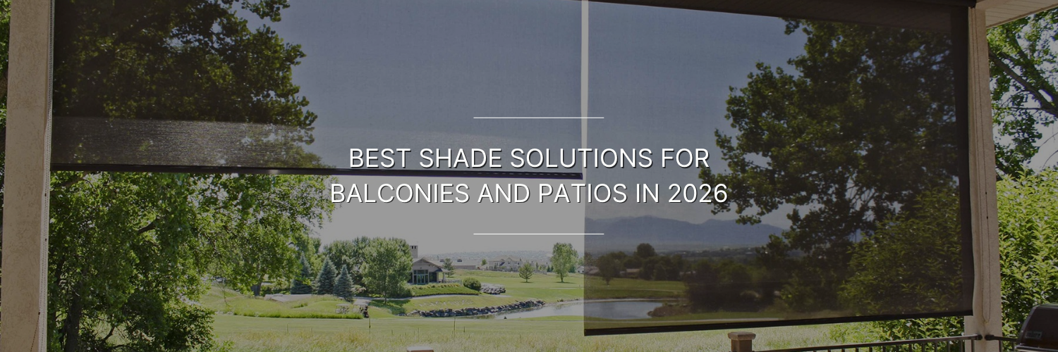 Outdoor balcony with black mesh roller shades partially lowering the sunny view of a lawn, trees, and distant hills.
