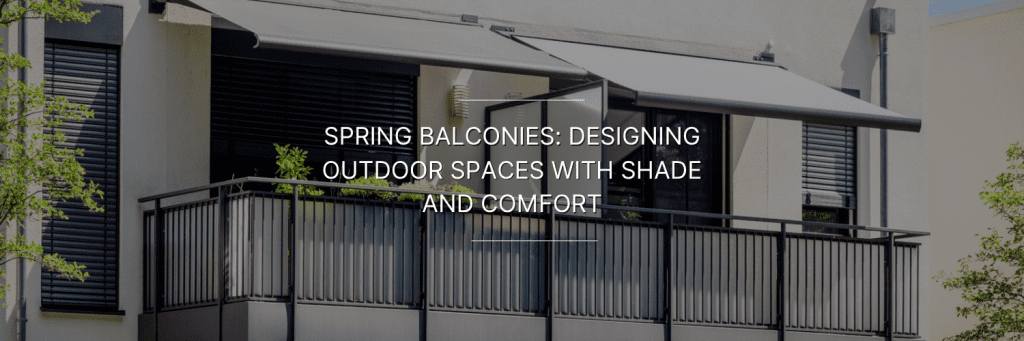 Modern apartment balcony with black railing, retractable gray awning for shade, and potted plants along the edge.