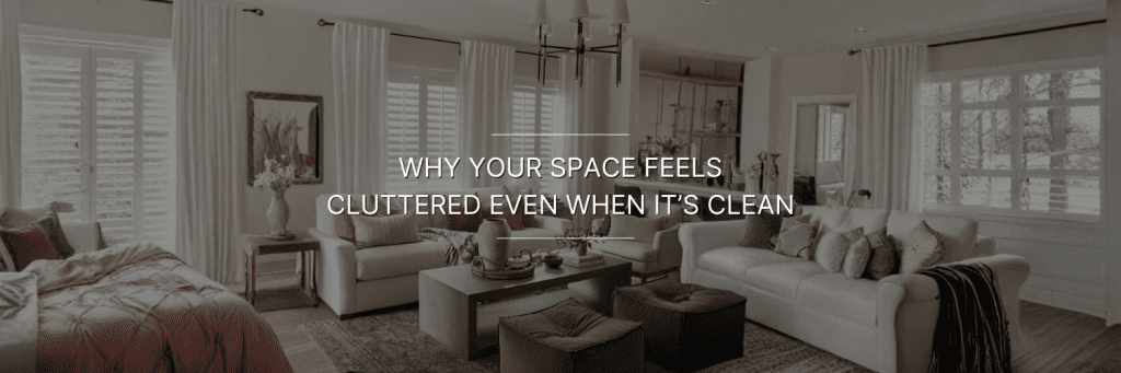 Elegant living room with neutral tones, white sofas, and soft lighting, conveying a cozy yet cluttered feel. Text overlay reads, "Why Your Space Feels Cluttered Even When It's Clean."